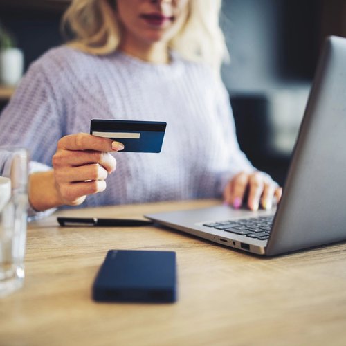 Person using a laptop to pay online by card - Fast and easy finance options with approved credit from Success Floor Covering LLC in Oakland, MD